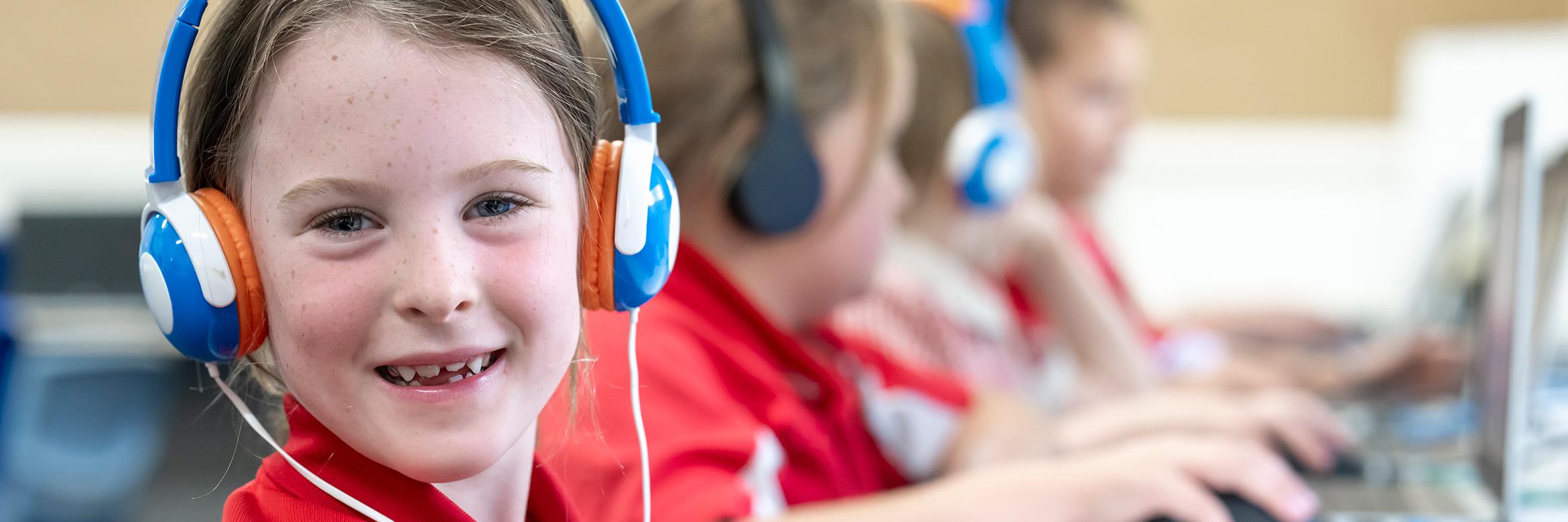 Girl wearing headphones in class